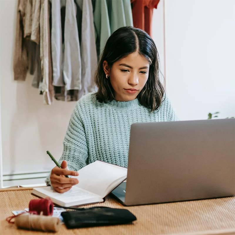 A young woman searching for jobs on a computer